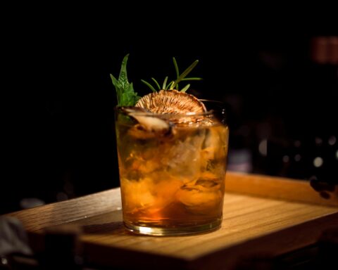 clear glass tumbler on brown wooden tray