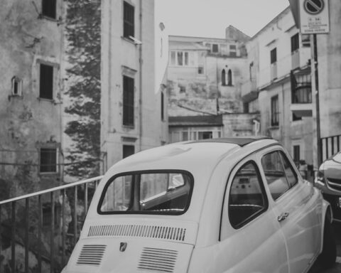 car parked beside railing in city