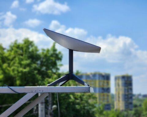 a white surfboard sitting on top of a metal pole