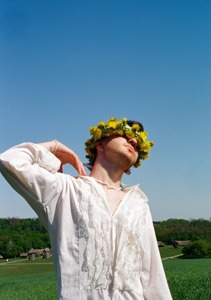 a man with a flower crown on his head