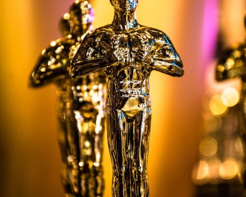 a number of oscar statues on a table