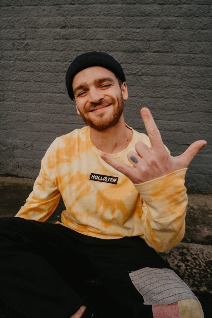 man in yellow crew neck shirt and black knit cap