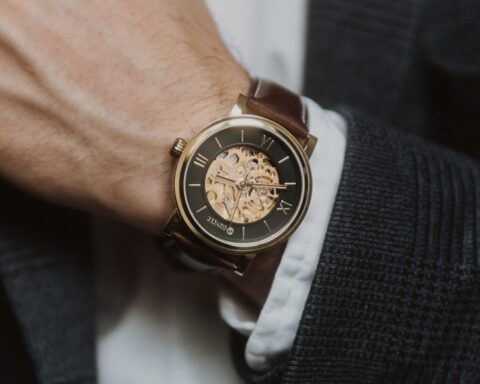 person wearing silver and gold chronograph watch